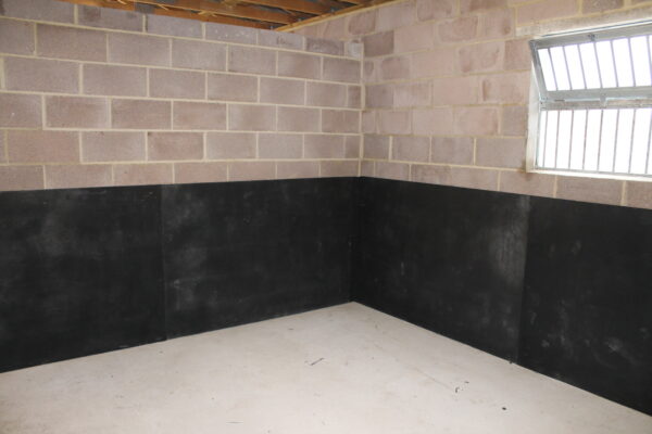 Black 10mm EVA installed onto a breeze block wall with our stable spray glue