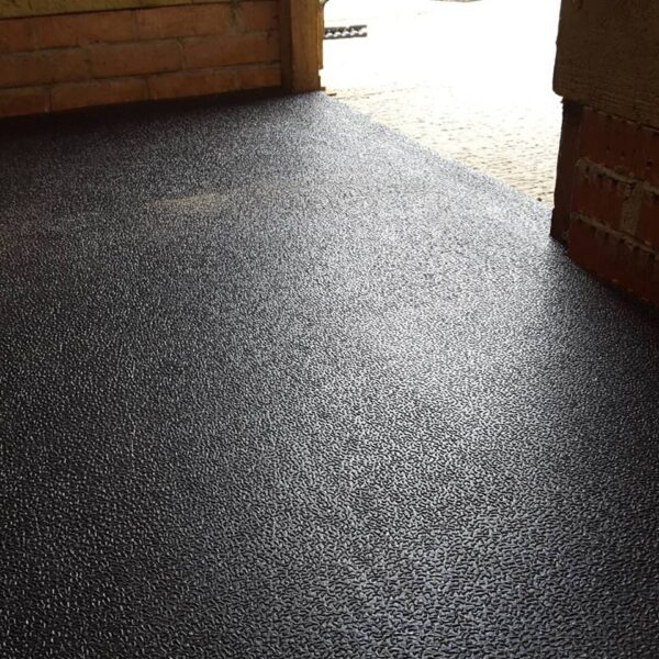 Low profile stable mats installed into a stable looking out of the door